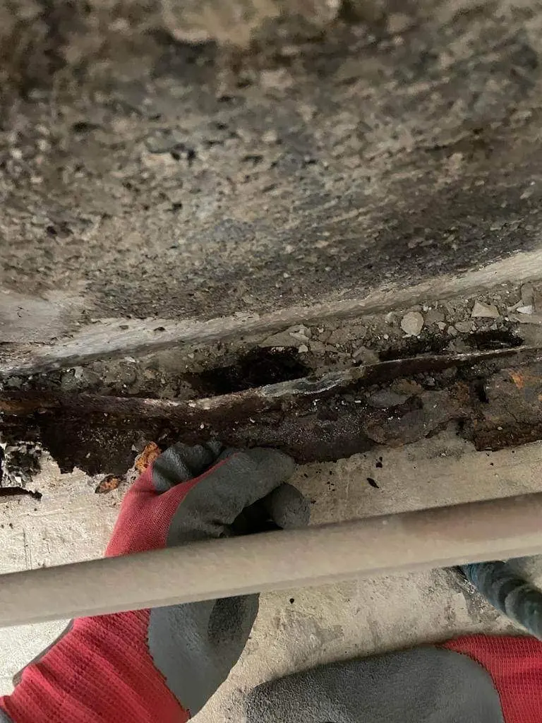 Élément en acier corrodé dans le mur humide